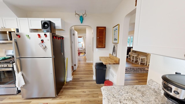 kitchen featuring light hardwood / wood-style floors, appliances with stainless steel finishes, and plenty of natural light