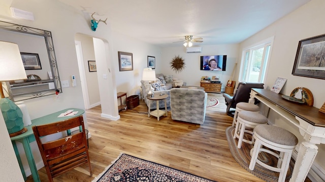 living room featuring ceiling fan and light hardwood / wood-style flooring