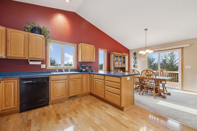 kitchen with dishwasher, dark countertops, a peninsula, an inviting chandelier, and a sink