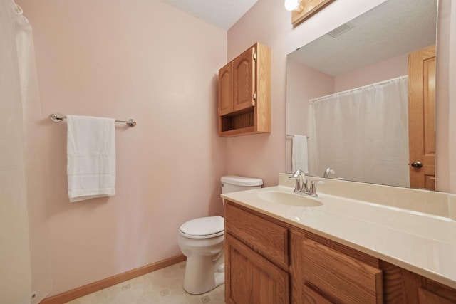 bathroom featuring a textured ceiling, toilet, vanity, visible vents, and baseboards