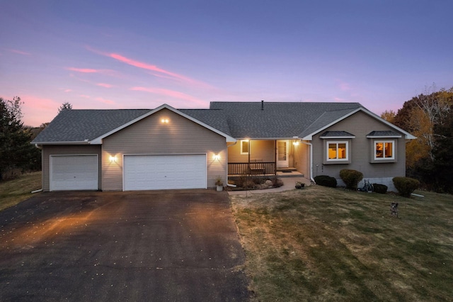 single story home with a porch, aphalt driveway, a garage, roof with shingles, and a front lawn