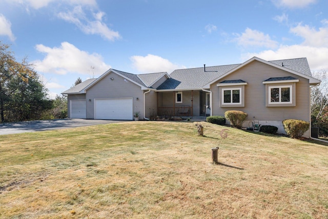 ranch-style house with a garage, a front lawn, and aphalt driveway