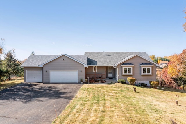 ranch-style home with a garage, aphalt driveway, roof with shingles, a front lawn, and a porch