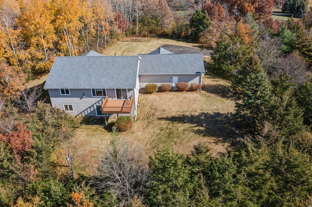 drone / aerial view featuring a wooded view