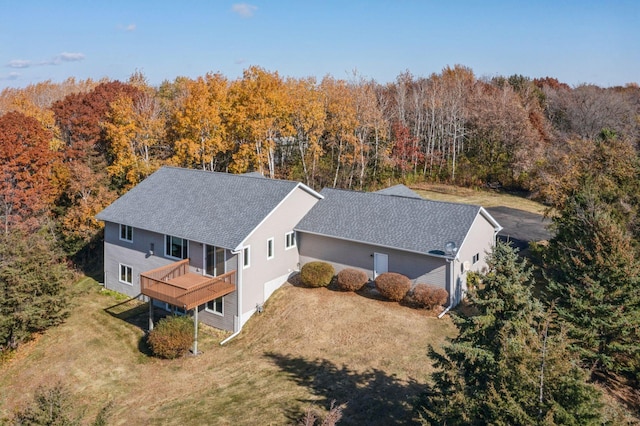 bird's eye view with a wooded view