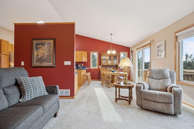 living room with light carpet, lofted ceiling, visible vents, and baseboards