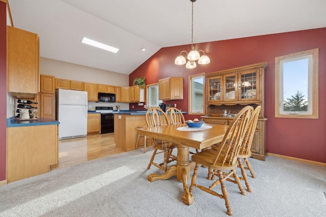 dining room featuring lofted ceiling, light colored carpet, an inviting chandelier, a healthy amount of sunlight, and baseboards