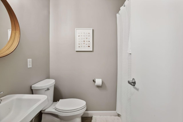 bathroom featuring toilet and sink