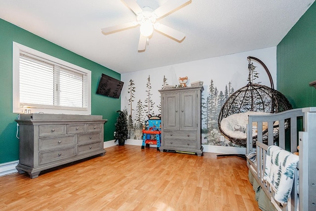 bedroom with light hardwood / wood-style floors and ceiling fan