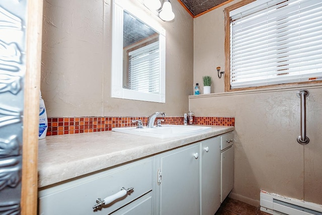 bathroom featuring vanity, plenty of natural light, and a baseboard heating unit