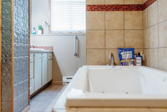 bathroom with baseboard heating, a bathing tub, tile patterned flooring, and tile walls