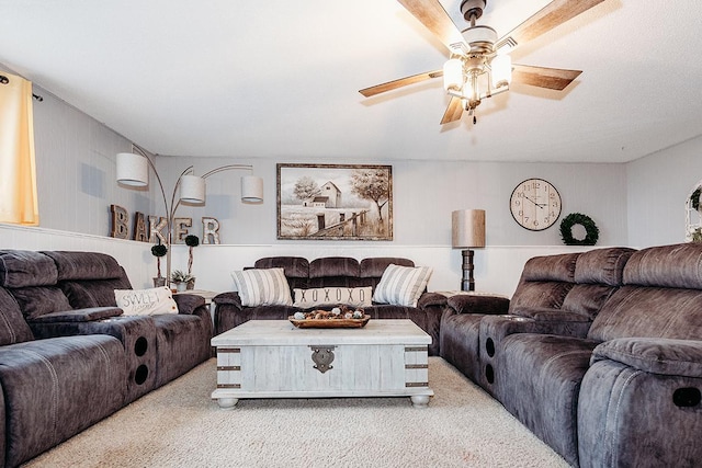 carpeted living room featuring ceiling fan