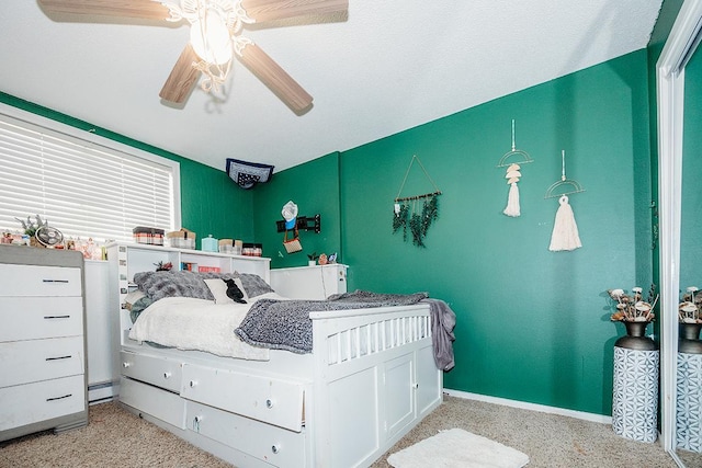 bedroom with a baseboard radiator and ceiling fan