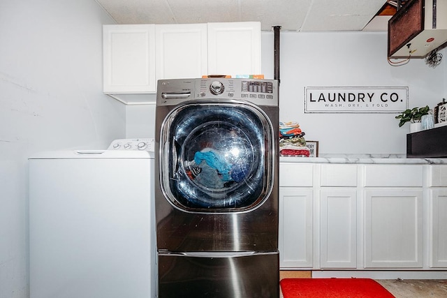 laundry area featuring cabinets and washer and dryer