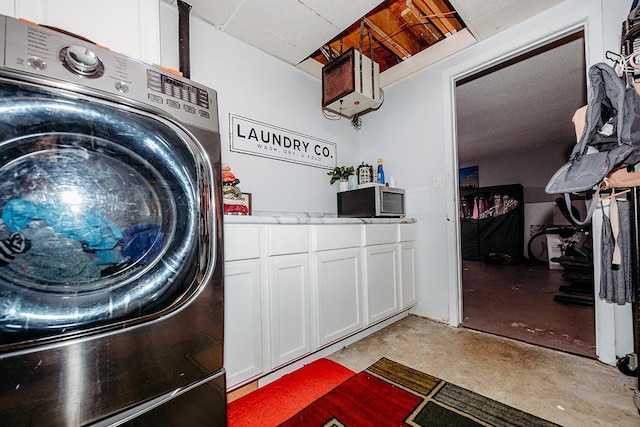 washroom featuring cabinets and washer / clothes dryer