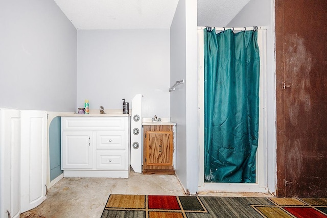 bathroom with a shower with curtain, vanity, and concrete floors