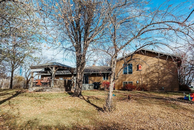 back of property featuring a yard