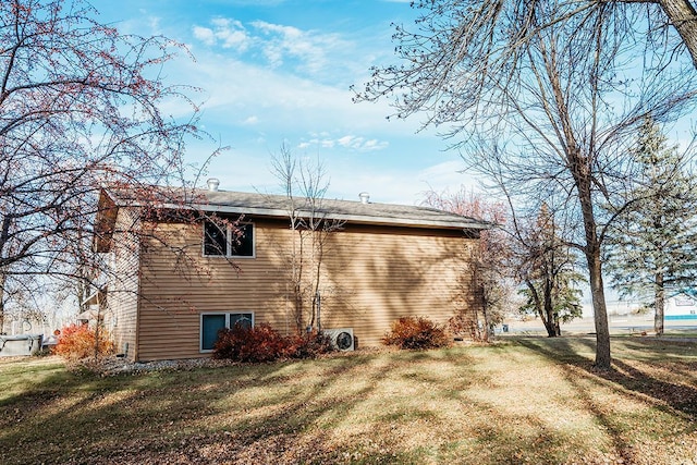 back of property featuring a lawn