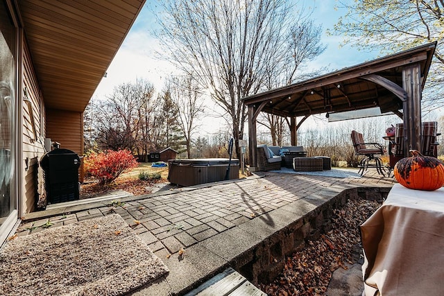 view of patio featuring a hot tub, a gazebo, an outdoor hangout area, and central AC unit