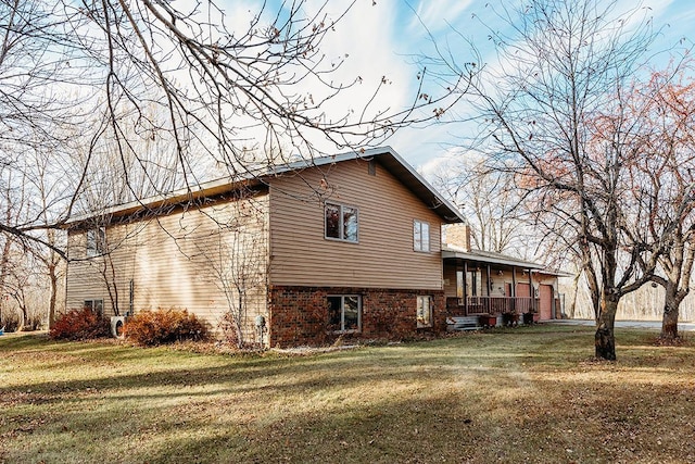 view of side of property with a lawn and a porch