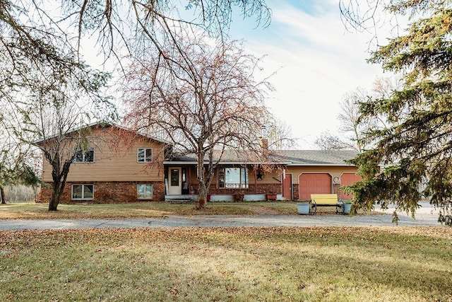 view of front of property featuring a garage and a front lawn