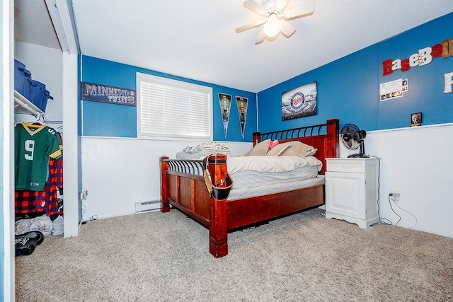 bedroom with ceiling fan, light colored carpet, and baseboard heating