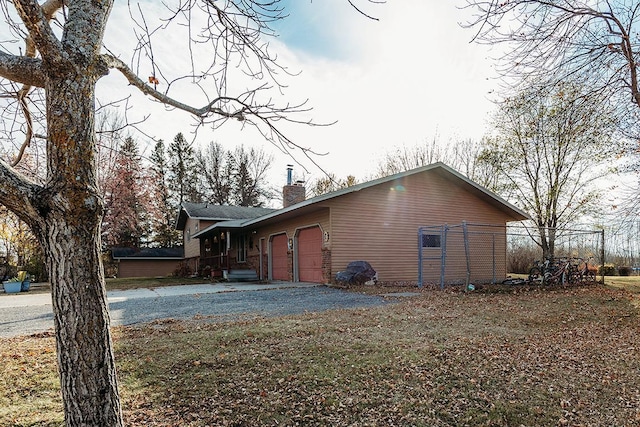 view of side of home featuring a garage