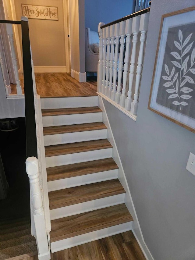 stairway with hardwood / wood-style flooring