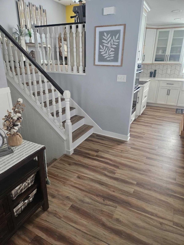 stairway featuring wood-type flooring