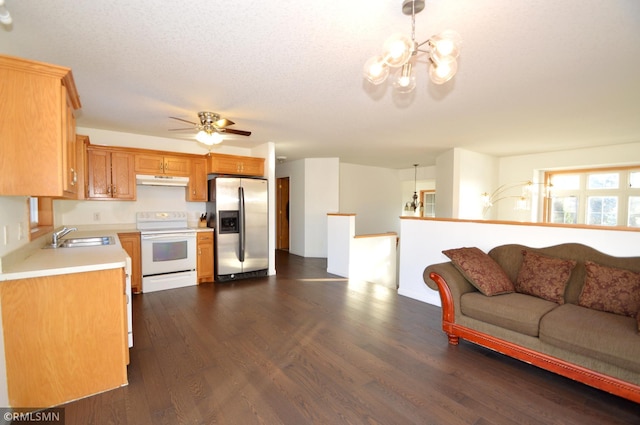 kitchen with sink, dark hardwood / wood-style flooring, white range with electric cooktop, stainless steel fridge, and decorative light fixtures