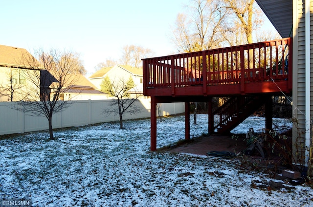 snowy yard featuring a deck