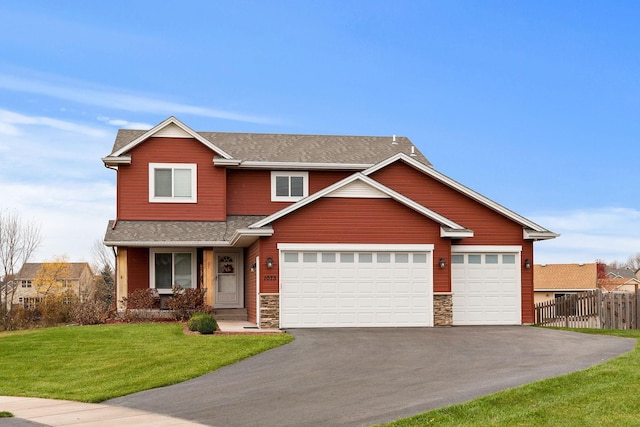 craftsman-style home featuring a garage and a front yard