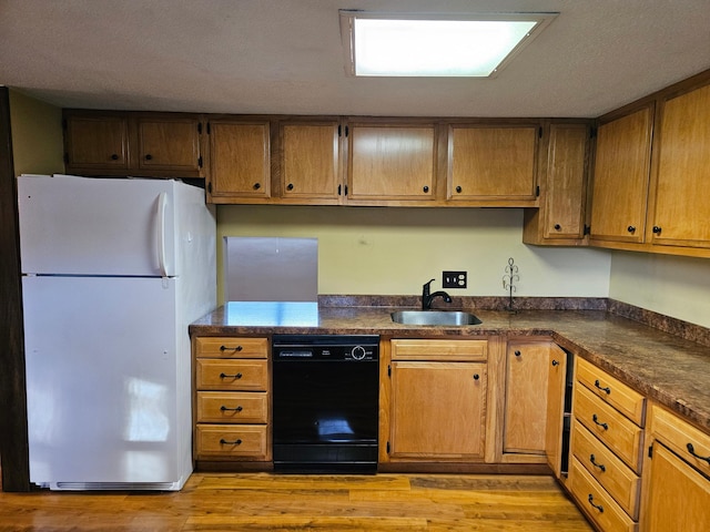 kitchen with black dishwasher, sink, light hardwood / wood-style floors, and white refrigerator