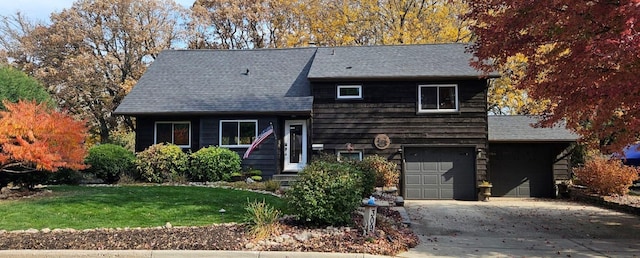 view of front of house with a front yard and a garage