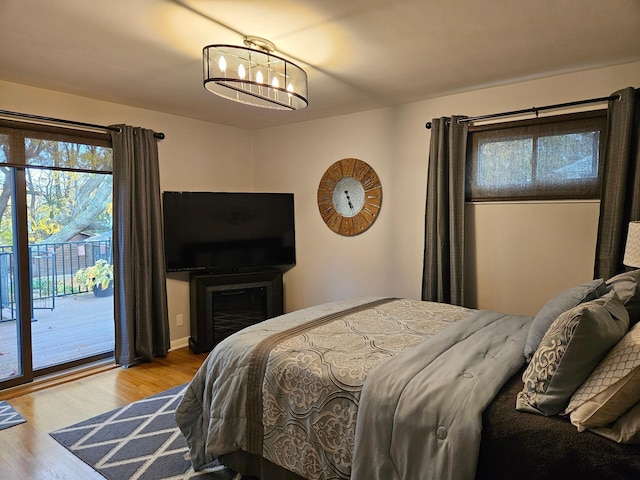 bedroom with light hardwood / wood-style flooring and access to exterior