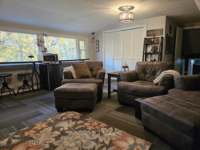 carpeted living room featuring lofted ceiling