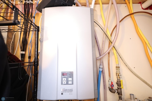 utility room with tankless water heater