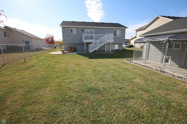 back of house with a lawn