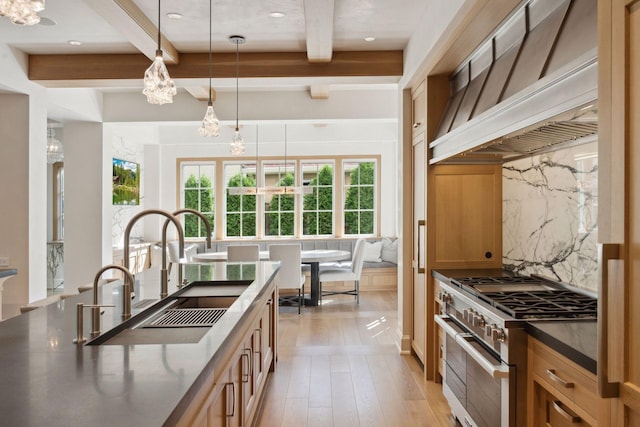 kitchen featuring hanging light fixtures, an inviting chandelier, light wood-type flooring, beamed ceiling, and high end range