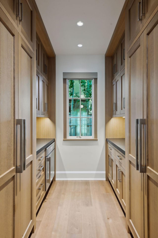 kitchen featuring light hardwood / wood-style floors and beverage cooler