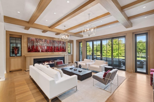 living room featuring light hardwood / wood-style floors, beam ceiling, a chandelier, and coffered ceiling