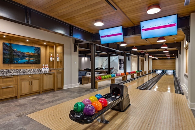 rec room with bowling and wooden ceiling