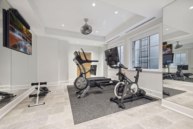 workout room featuring a raised ceiling