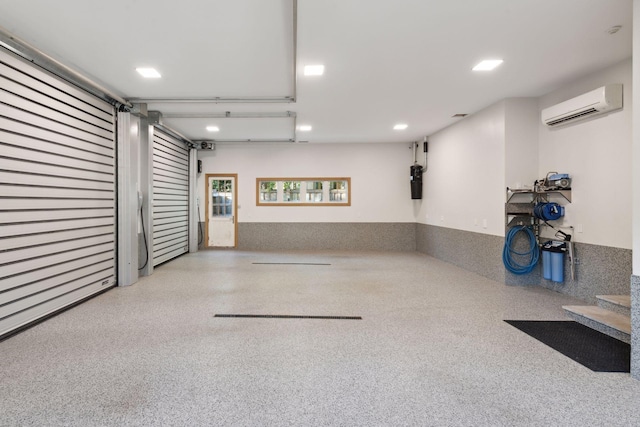 garage featuring a wall mounted AC