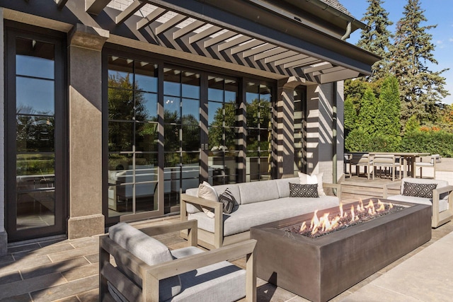 view of patio featuring an outdoor living space with a fire pit