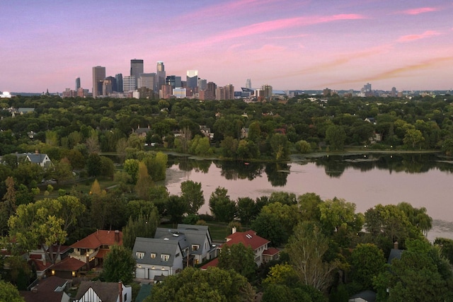 aerial view at dusk featuring a water view