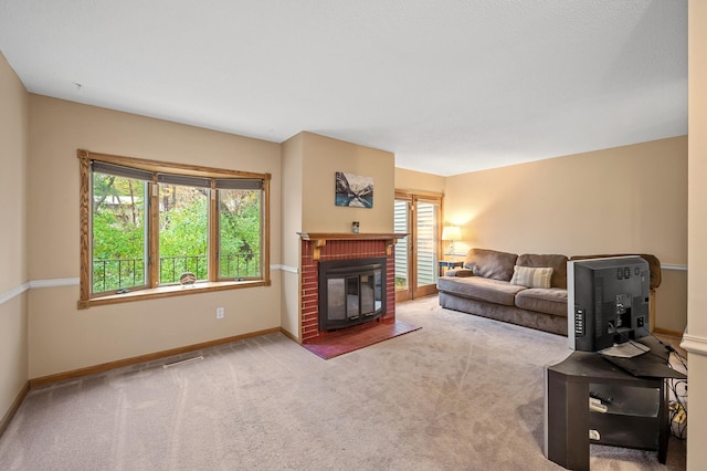 carpeted living room with a fireplace