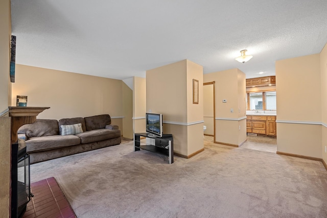 carpeted living room featuring a textured ceiling