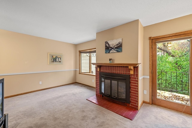 carpeted living room featuring plenty of natural light and a fireplace