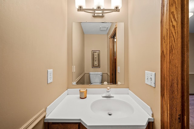 bathroom featuring vanity and toilet